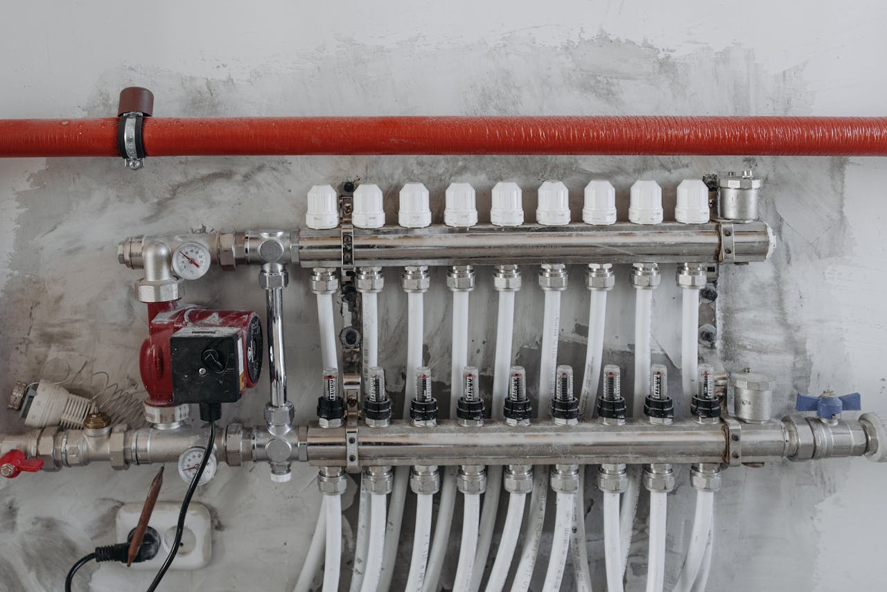 services-03 A close-up view of an industrial manifold with pressure gauges and connected steel pipes.